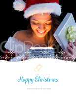 Composite image of pretty brunette in santa outfit opening gift