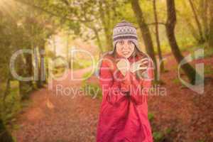 Composite image of cold redhead wearing coat and hat