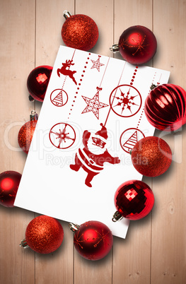 Composite image of hanging red christmas decorations