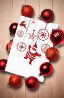 Composite image of hanging red christmas decorations