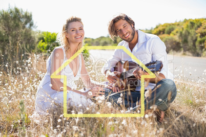 Composite image of handsome man serenading his girlfriend with g