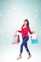 Composite image of excited brunette with shopping bags