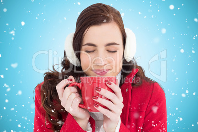 Composite image of woman in winter clothes enjoying a hot drink