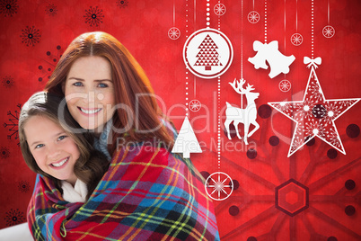 Composite image of mother and daughter under blanket