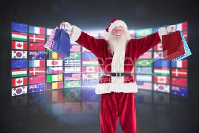 Composite image of santa holds some bags for chistmas