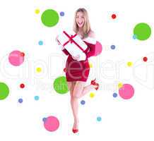 Composite image of pretty santa girl smiling at camera