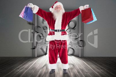 Composite image of santa holds some bags for chistmas