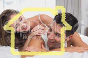 Composite image of romantic young couple in bed at home
