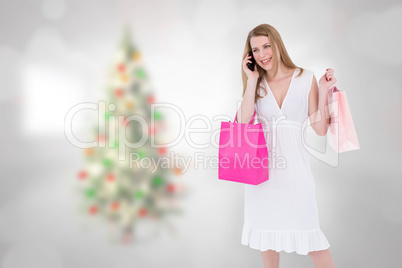 Composite image of happy blonde holding shopping bags and talkin