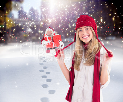 Composite image of pretty blonde smiling at camera in warm cloth