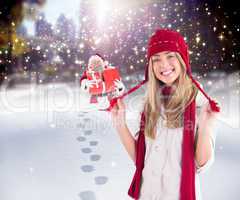 Composite image of pretty blonde smiling at camera in warm cloth