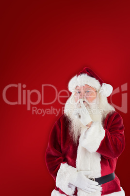 Composite image of santa asking for quiet to camera