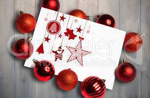 Composite image of hanging red christmas decorations