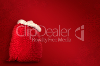 Composite image of santas red bag standing alone
