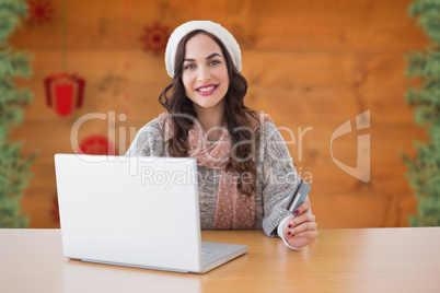 Composite image of woman with credit card