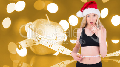 Composite image of fit festive young blonde measuring her waist