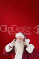 Composite image of santa claus enjoys some music