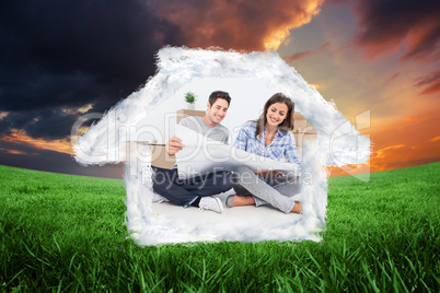 Composite image of man and woman looking at their house plans