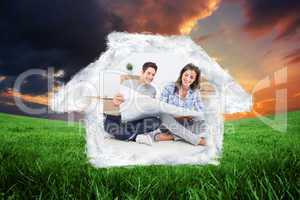 Composite image of man and woman looking at their house plans