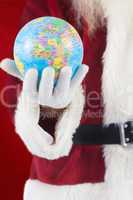 Composite image of santa has a globe in his hand