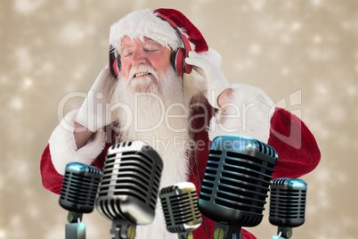 Composite image of santa claus enjoys some music
