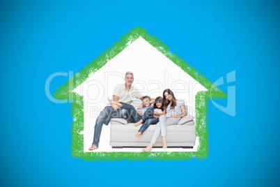 Composite image of family sitting on sofa smiling at camera