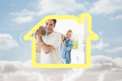 Composite image of couple carrying rolled rug after moving in a