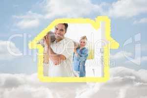 Composite image of couple carrying rolled rug after moving in a