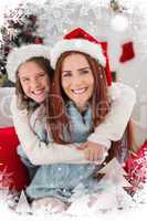 Composite image of festive mother and daughter on the couch