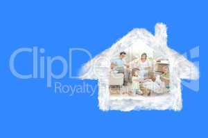 Composite image of family unpacking cardboard box