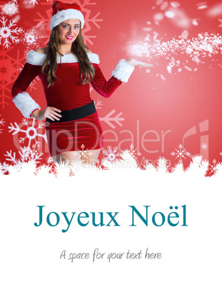 Composite image of pretty girl in santa costume holding hand out