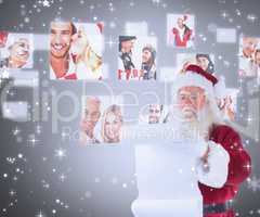 Composite image of santa claus reads a list