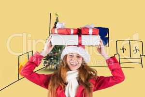 Composite image of festive redhead holding pile of gifts