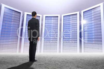 Composite image of businessman turning his back to camera