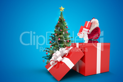 Composite image of santa standing in large gift