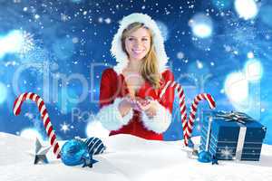 Composite image of pretty girl holding hands out in santa outfit