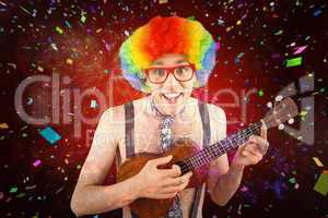 Composite image of geeky hipster in afro rainbow wig playing gui