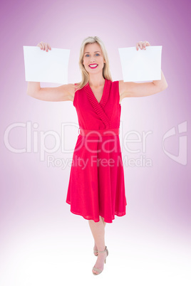 Stylish blonde in red dress holding pages