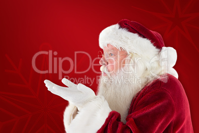 Composite image of santa claus blows something away