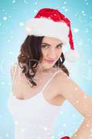 Composite image of portrait of a pretty brunette in santa hat