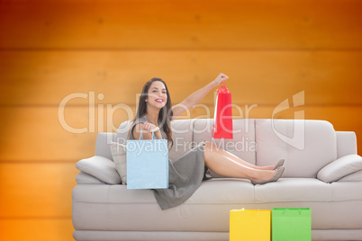 Composite image of woman lying on couch