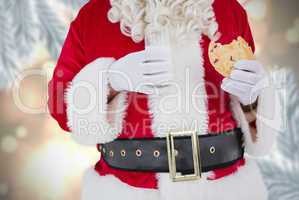 Composite image of santa having milk and cookie