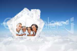 Composite image of happy family having fun lying down on bed