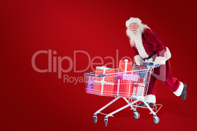 Composite image of santa rides on a shopping cart