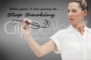 Composite image of serious businesswoman looking at pen in her h