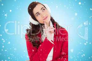 Composite image of smiling brunette in winter wear thinking