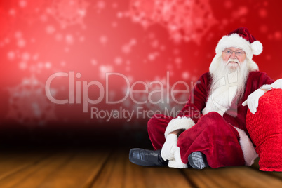 Composite image of santa sits next to his bag