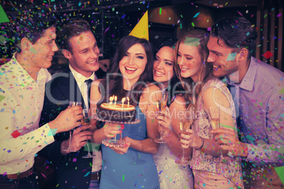 Composite image of attractive friends celebrating a birthday