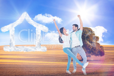 Composite image of happy casual couple cheering together