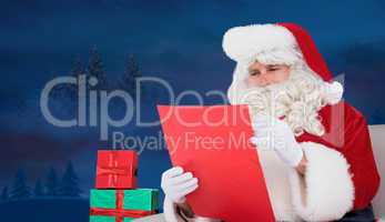 Composite image of santa checking list